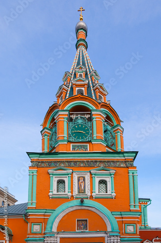 The bell tower with the clock tower of the Church of Gregory of Neocaesarea in Moscow photo