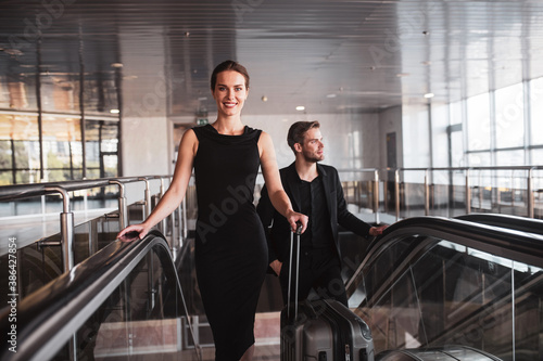 Smiling woman arriving at the airport or the business trip photo