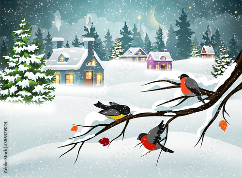 Christmas village and bullfinches on a branch