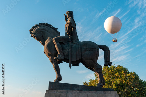 Statue of King Vakhtang Gorgasali in Tbilisi, Air excursion balloon for passengers against the blue sky