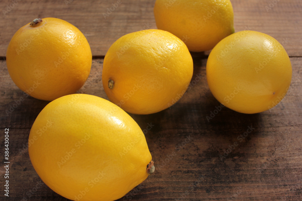 Close-up of fresh yellow lemons on wooden table. Flat lay, copy space Close-up of fresh yellow lemons on wooden table. Flat lay, copy space