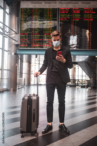 Man using his smartphone in the airport photo