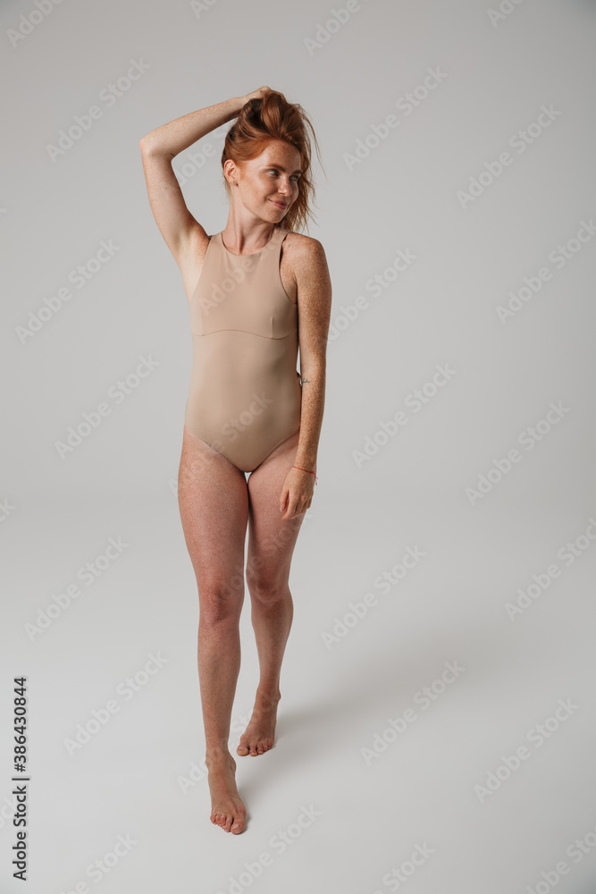 Beautiful young woman with long red hair in bodysuit Beautiful young woman with long red hair in bodysuit