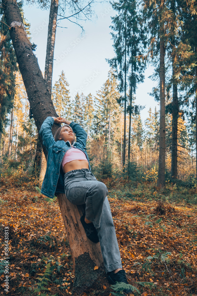 A girl in the woods on a tree, a view from above. A girl in the woods on a tree, a view from above.