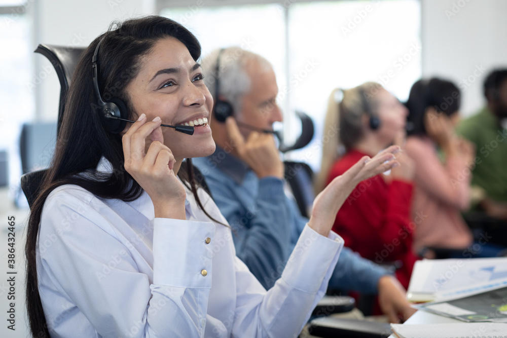 Businesswoman wearing headset working at office Businesswoman wearing headset working at office