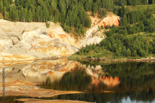 quarries in the place of mining and red refractory clay against the backdrop of red clay mountains and quarries photo