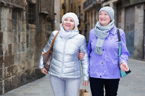Happy elderly women enjoying walk around town during join travel © JackF