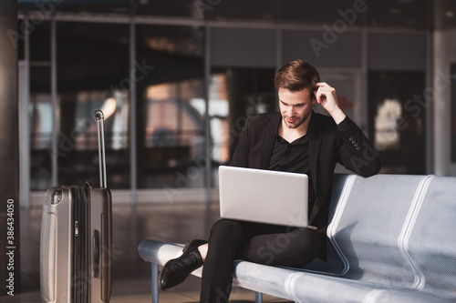 Man dealing with his task while waiting for the boarding photo