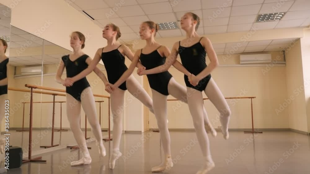 A group of young ballerinas rehearse the ballet Swan lake at the ballet school. Slow motion. A group of young ballerinas rehearse the ballet Swan lake at the ballet school. Slow motion.