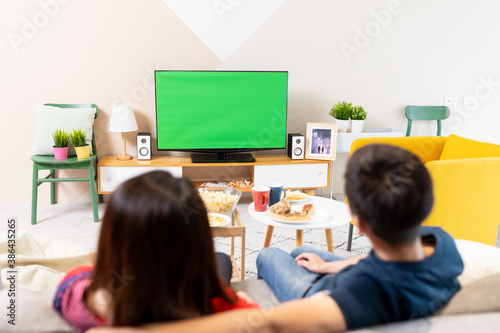 couple watch green screen TV