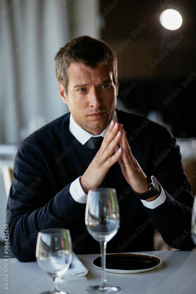 Handsome businessman drinking wine. Businessman enjoying in the restaurant.