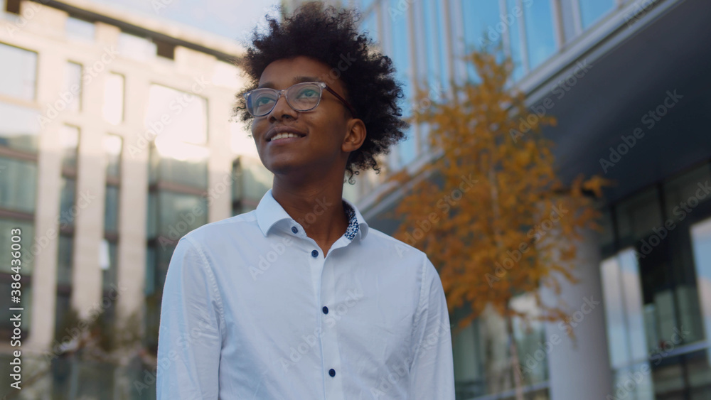 Portrait of young afro american businessman standing outdoors business center Portrait of young afro american businessman standing outdoors business center