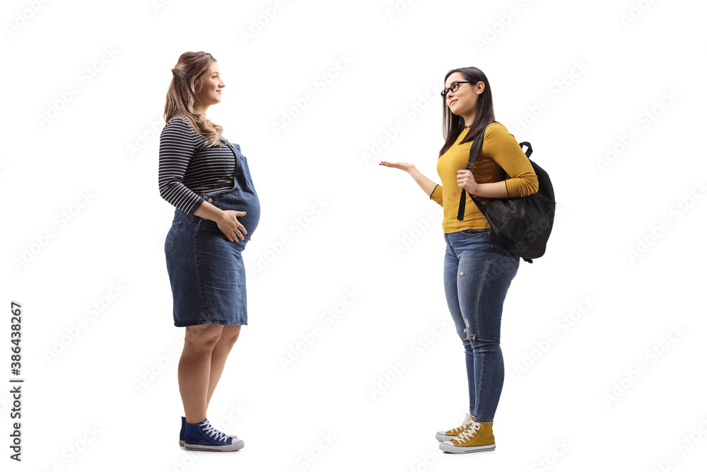 Full length profile shot of a pregnant woman and a female student having a conversation Full length profile shot of a pregnant woman and a female student having a conversation