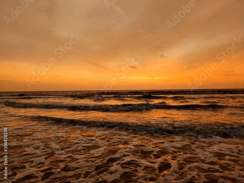sunset over the waves of sea