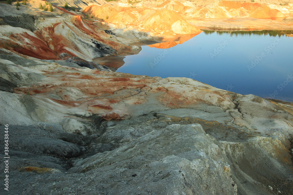 quarries in the place of mining and red refractory clay against the backdrop of red clay mountains and quarries