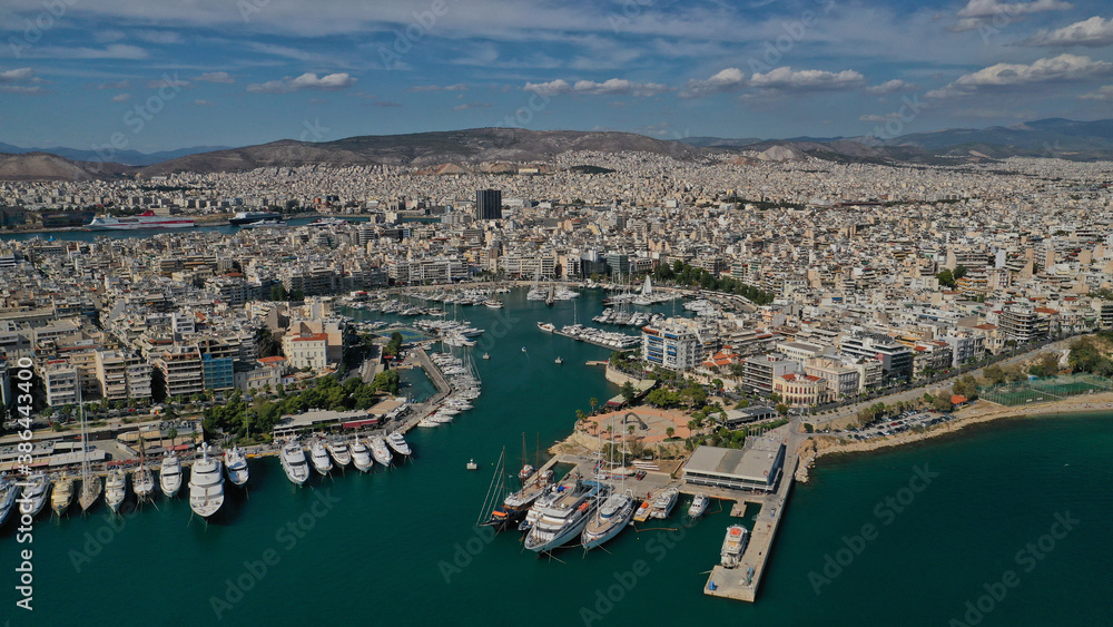 Aerial drone panoramic photo of iconic round port and marina of Zea in the heart of Piraeus with beautiful sky and clouds, Attica, Greece