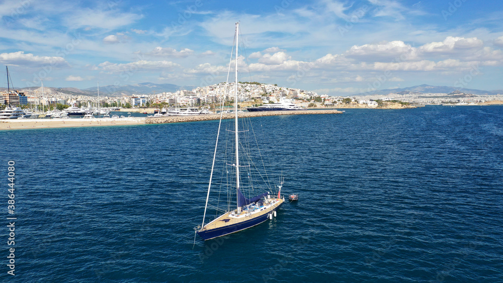 Aerial drone photo of beautiful luxury sailboat with wooden deck anchored near famous marina of Zea, Piraeus, Attica, Greece