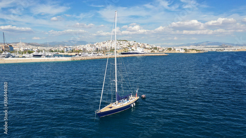 Aerial drone photo of beautiful luxury sailboat with wooden deck anchored near famous marina of Zea, Piraeus, Attica, Greece © aerial-drone