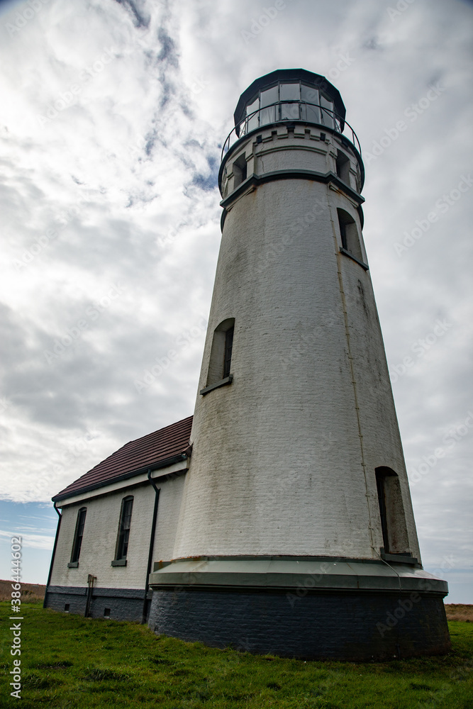 red and white lighthouse on a grassy hill red and white lighthouse on a grassy hill