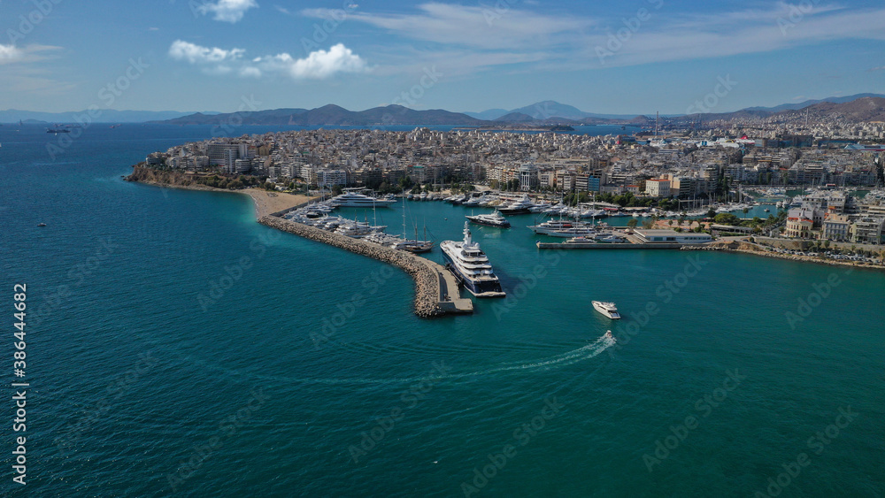 Obraz premium Aerial drone panoramic photo of iconic round port and marina of Zea in the heart of Piraeus with beautiful sky and clouds, Attica, Greece