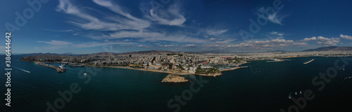 Fototapeta Naklejka Na Ścianę i Meble -  Aerial drone panoramic photo of iconic round port and marina of Zea in the heart of Piraeus with beautiful sky and clouds, Attica, Greece