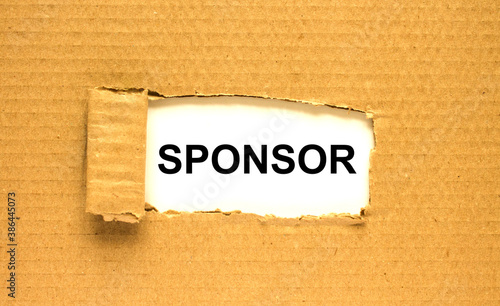 The word Sponsor appearing behind torn brown paper