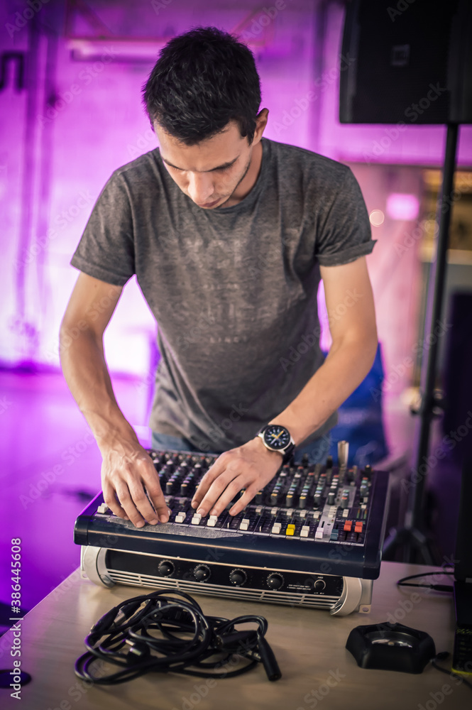 Behind the scene. Sound technician electric engineer adjusting sound