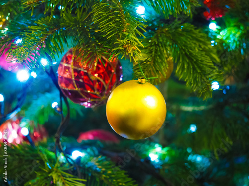 New Year night greeting card concept, soft focus. New year holiday or christmas  background. Branches of christmas tree with  decorations and lights, garlands and toys