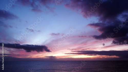 Seascape at early morning, first light. Time lapse of clouds moving over sea at sunrise dawn. Nature landscape in Spain.