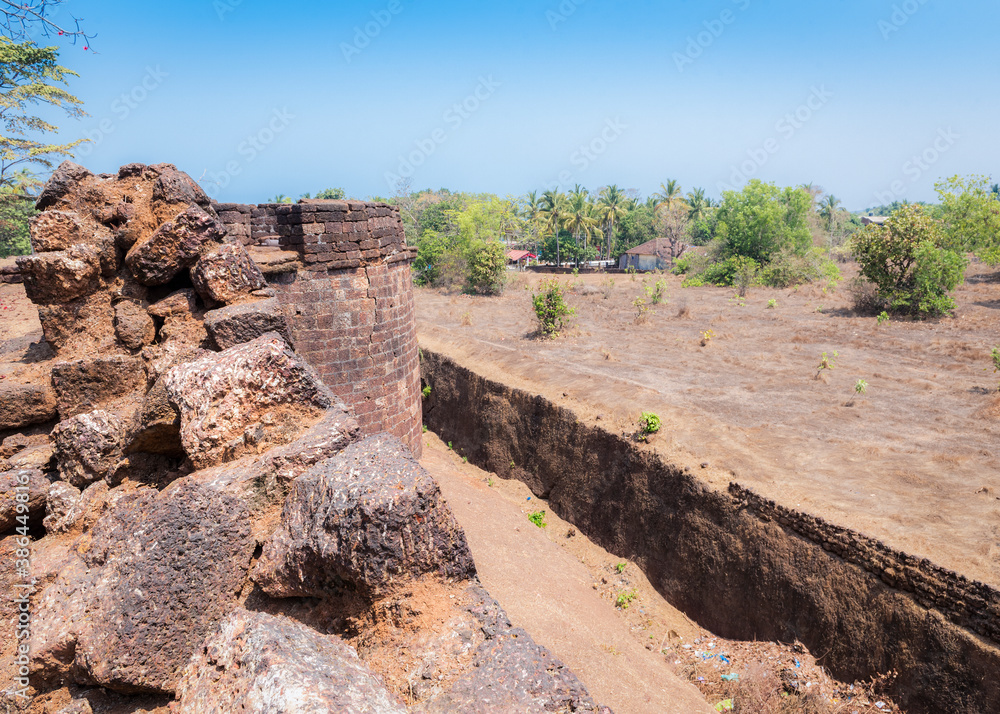 View of the old stone tower of the Portuguese fortress Fort Cabo De Rama near the village in Goa, India