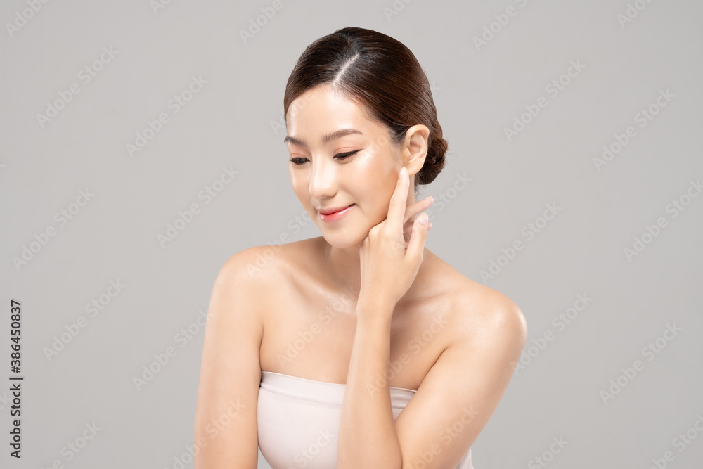 Beautiful Asian woman touching soft cheek smile with clean and fresh skin Happiness and cheerful with positive emotional,isolated on white background,Beauty and Cosmetics Concept