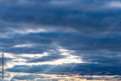 blue sky background with white clouds sun rays autumn day