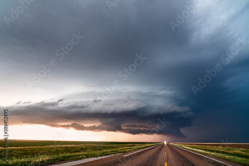 Supercell storm clouds over a road