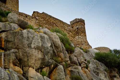 Castle wall on weathered granite rocks photo