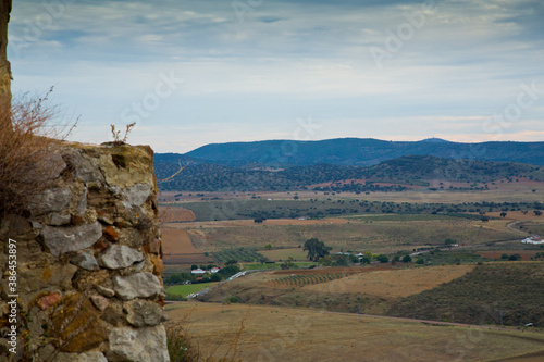 Valley view with crop fields and cloudy sky photo