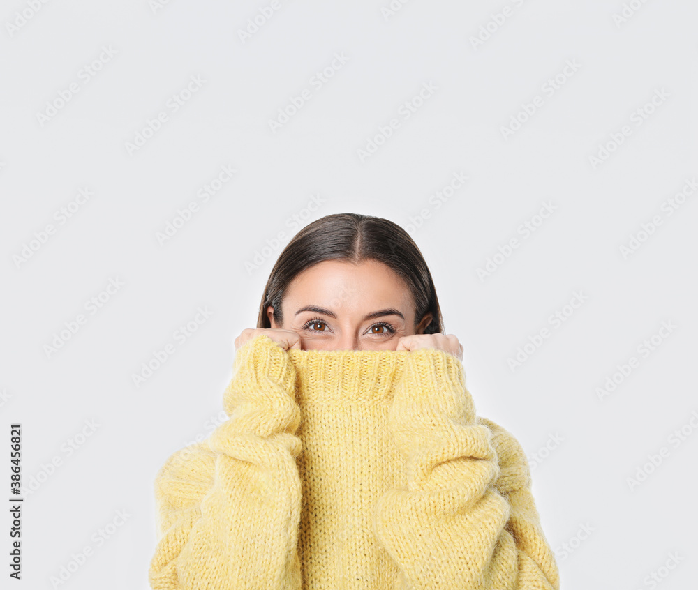 Young woman in stylish yellow sweater on white background Young woman in stylish yellow sweater on white background