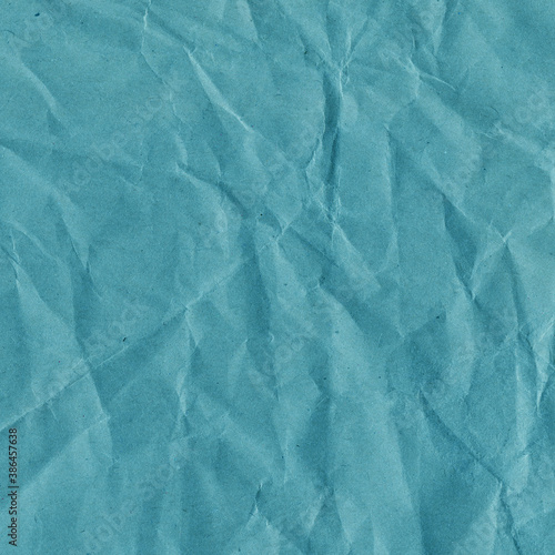 Blue vintage and old looking crumpled paper background. Retro cardboard texture. Grunge paper for drawing. Ancient book page. Present wrapping.