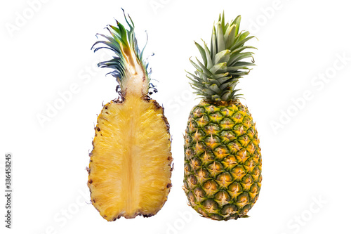 A single whole pineapple and cut in half isolated on white background.(Ananas comosus) is a tropical plant with an edible fruit and the most economically significant plant in the family Bromeliaceae.