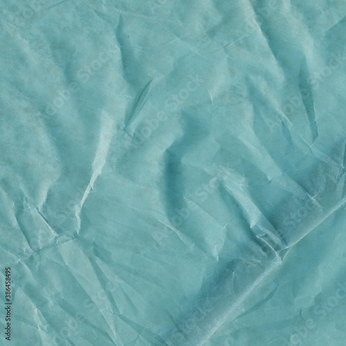 Blue vintage and old looking crumpled paper background. Retro cardboard texture. Grunge paper for drawing. Ancient book page. Present wrapping.