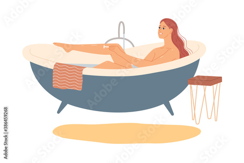 Woman in the bath shaves her legs