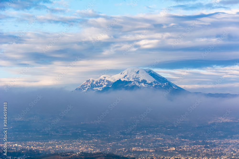 Chimborazo and Carihuayrazo volcanoes at sunrise with the city of Ambato