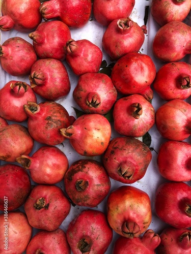 Ripe juicy pomegranates on the market macro
