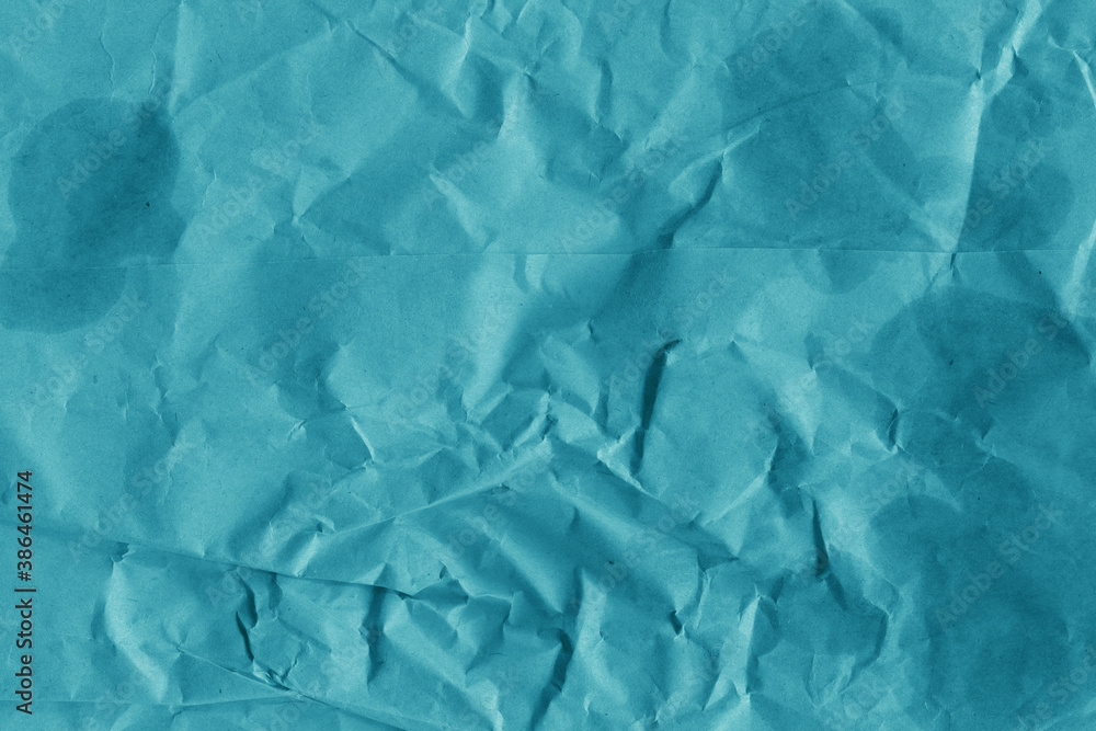 Fototapeta premium Blue vintage and old looking crumpled paper background. Retro cardboard texture. Grunge paper for drawing. Ancient book page. Present wrapping.