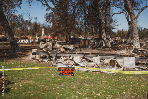 фотографія Private Property No Trespassing sign with yellow tape at burned park