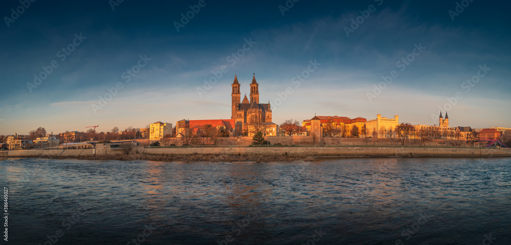 Panoramic view over downtown of Magdeburg, old town, Elbe river and Magnificent Cathedral at early Autumn and warm sunset, Magdeburg, Germany.