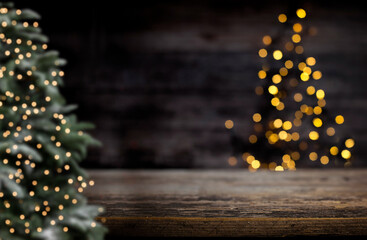 blurred background of xmas tree lights and wall wooden board and free place