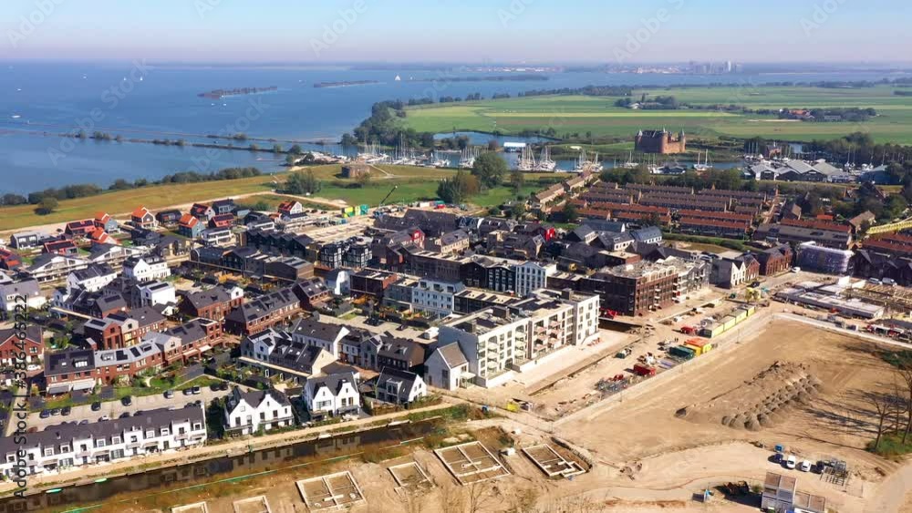 Muiden, Noord-Holland / Netherlands - October 10th 2020: Aerial view of the new housing estate in Muiden called ‘De Krijgsman’. Muiden, Noord-Holland / Netherlands - October 10th 2020: Aerial view of the new housing estate in Muiden called ‘De Krijgsman’.