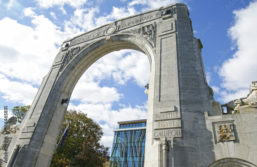 Naklejka premium Arch at Bridge of Remembrance on a cloudy day. Landmark located at City Center in Christchurch, New Zealand. 