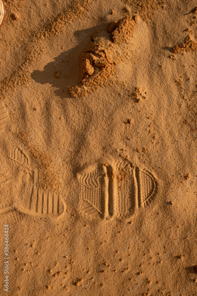 Fototapeta premium Human footprint on the sand texture