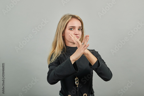 Let's make a stop I don't want to listen your lie. Unhappy depressed unsatisfied troubled annoyed, hold hands crossed showing negative reaction say no killing animals volunteer, hand holding